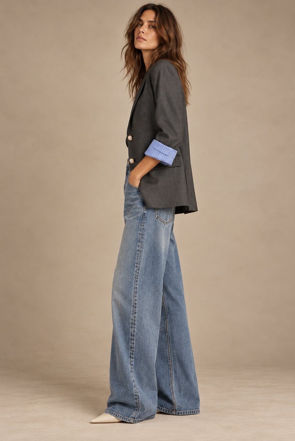 Side view of charcoal vintage blazer with striped cuff and wide-leg jeans