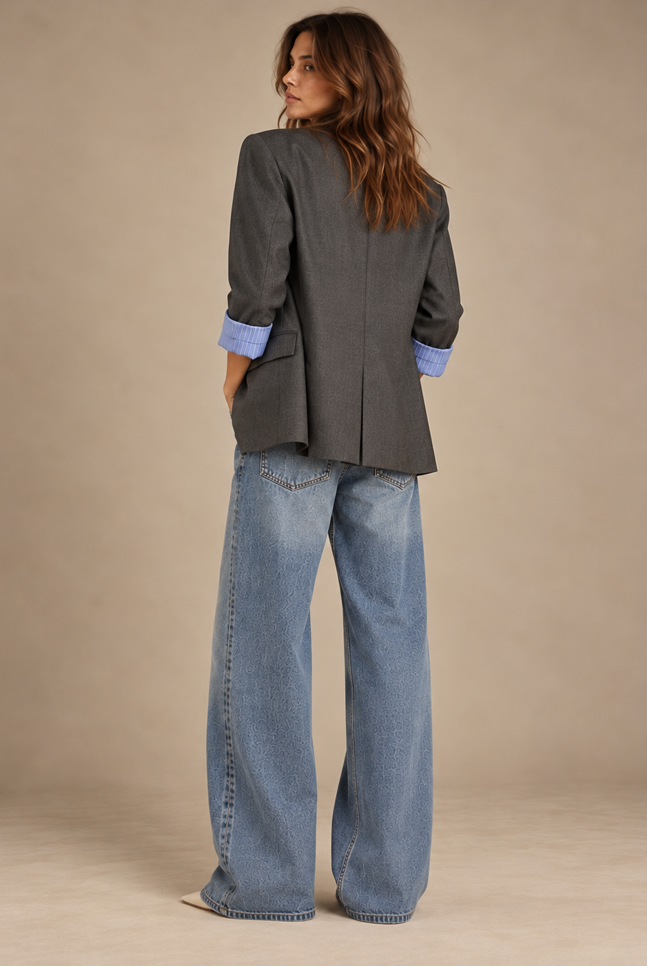 Back view of oversized charcoal blazer with centre vent and rolled sleeves
