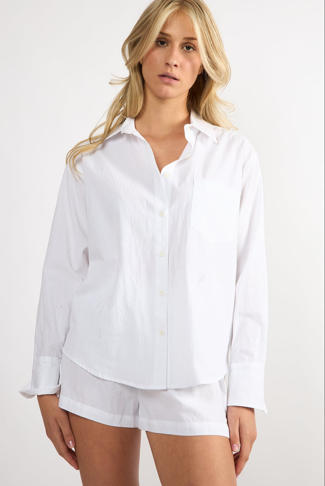 Model wearing a white embroidered cotton Everyday Boyfriend Shirt with a relaxed fit and button-down front.
