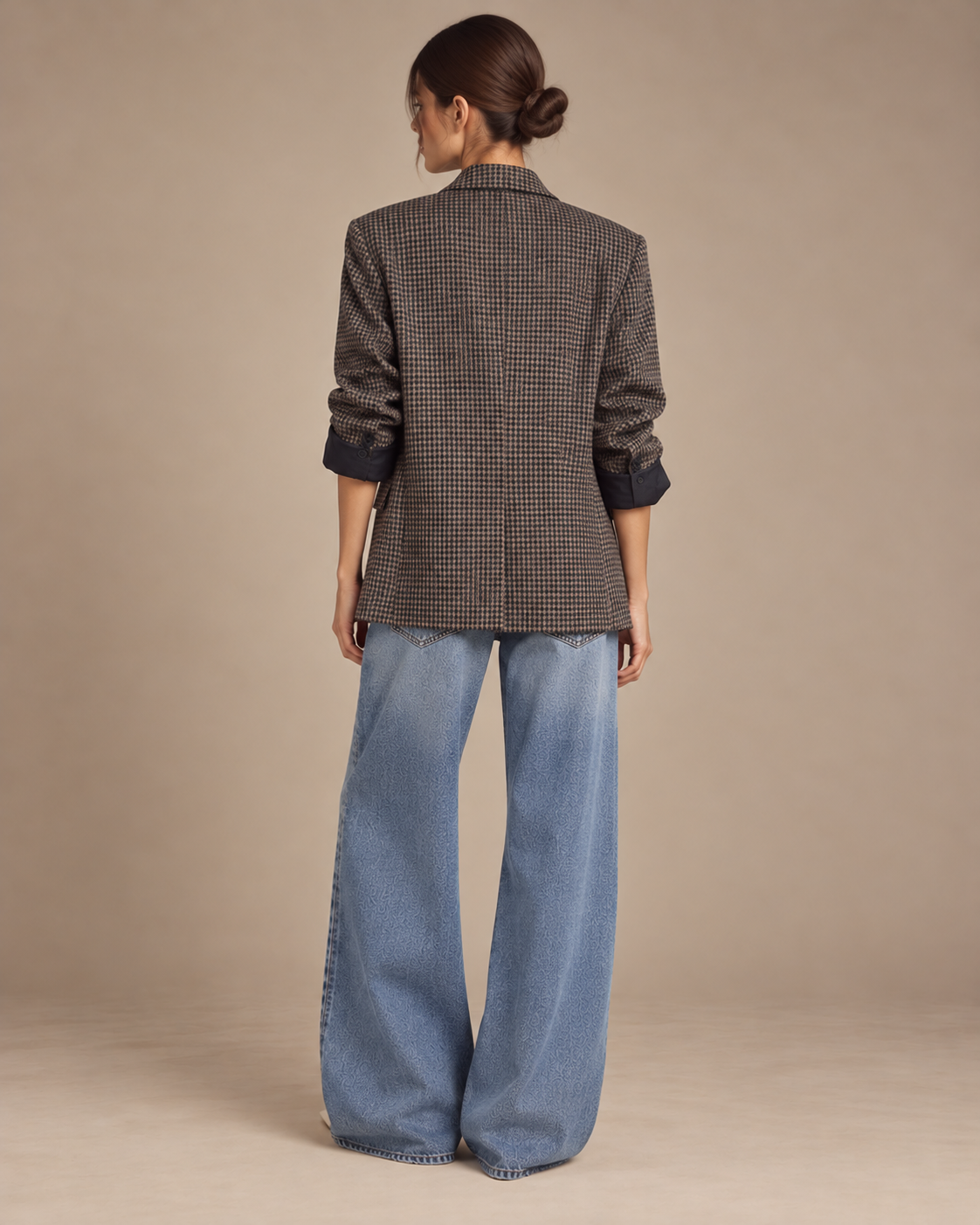 Back view of oversized navy and camel check blazer with rolled sleeves