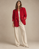 Red vintage blazer styled with white tank and cream wide-leg trousers