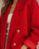 Close-up of red blazer peak lapel and gold anchor-crest buttons