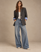 Vintage oversized charcoal grey blazer worn with white tank and baggy wide-leg jeans