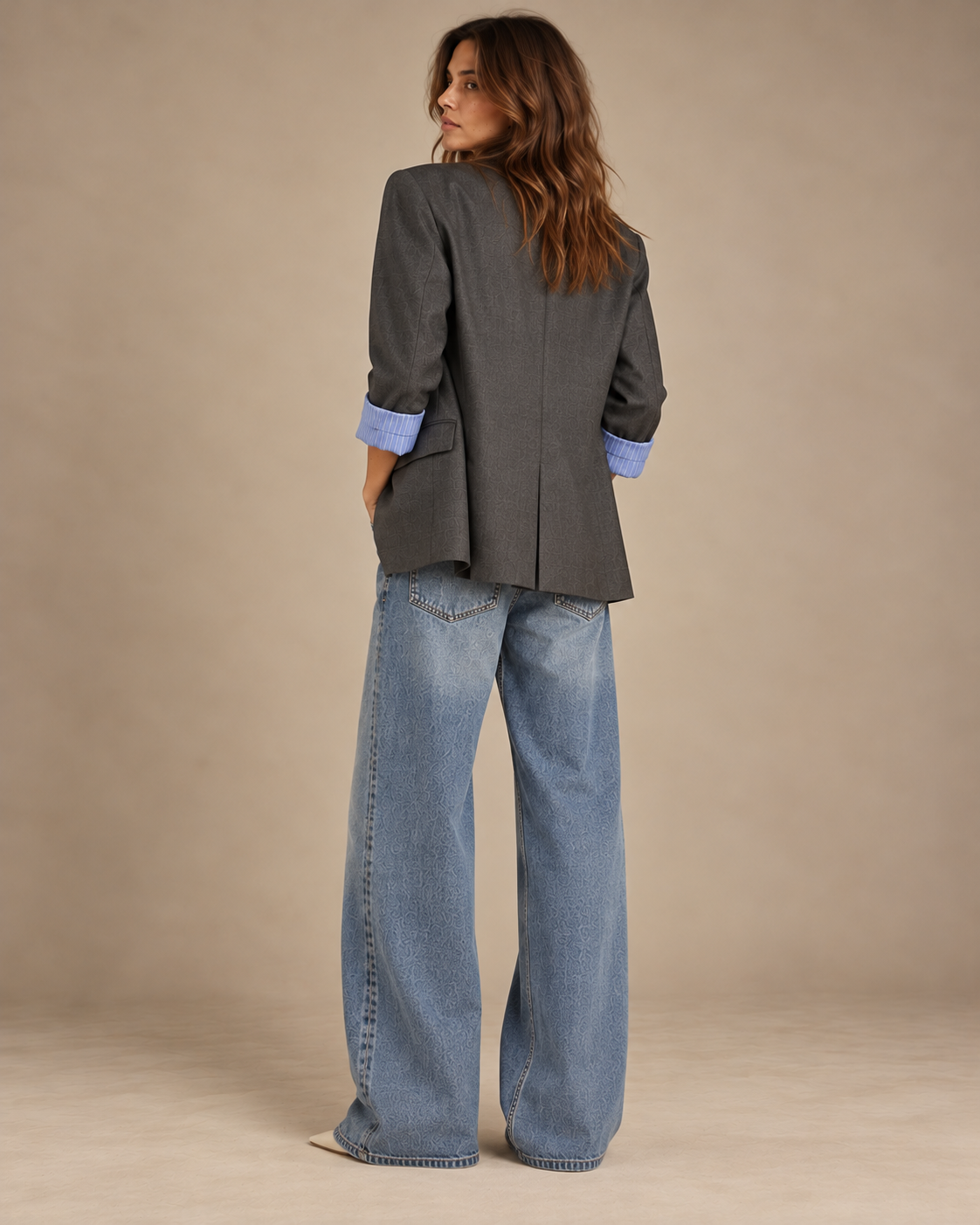 Back view of oversized charcoal blazer with centre vent and rolled sleeves