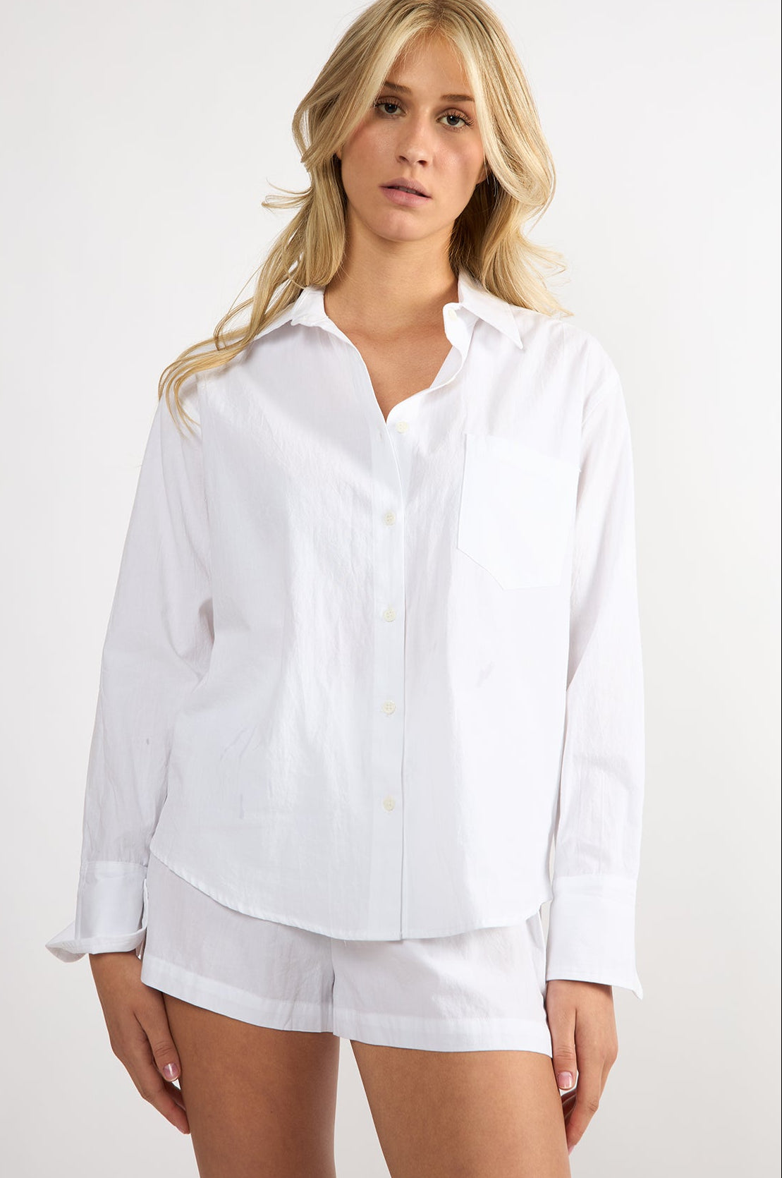 Model wearing a white embroidered cotton Everyday Boyfriend Shirt with a relaxed fit and button-down front.