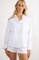 Model wearing a white embroidered cotton Everyday Boyfriend Shirt with a relaxed fit and button-down front.