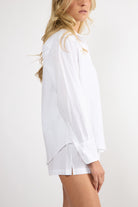 Model wearing a white embroidered cotton Everyday Boyfriend Shirt with a relaxed fit.