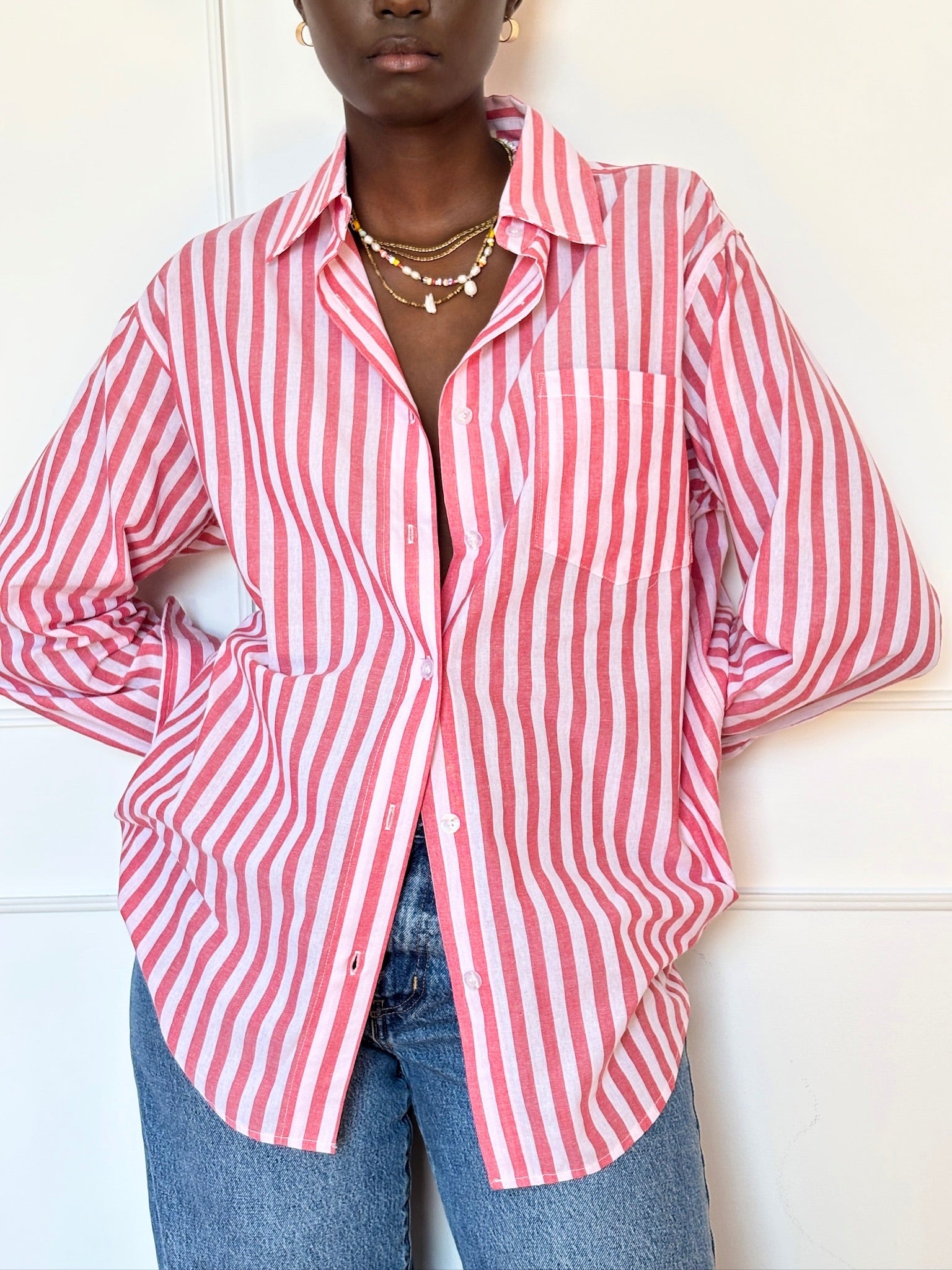 Red and white striped Summer Boxer Boyfriend Shirt in soft cotton, oversized fit, unbuttoned over jeans.