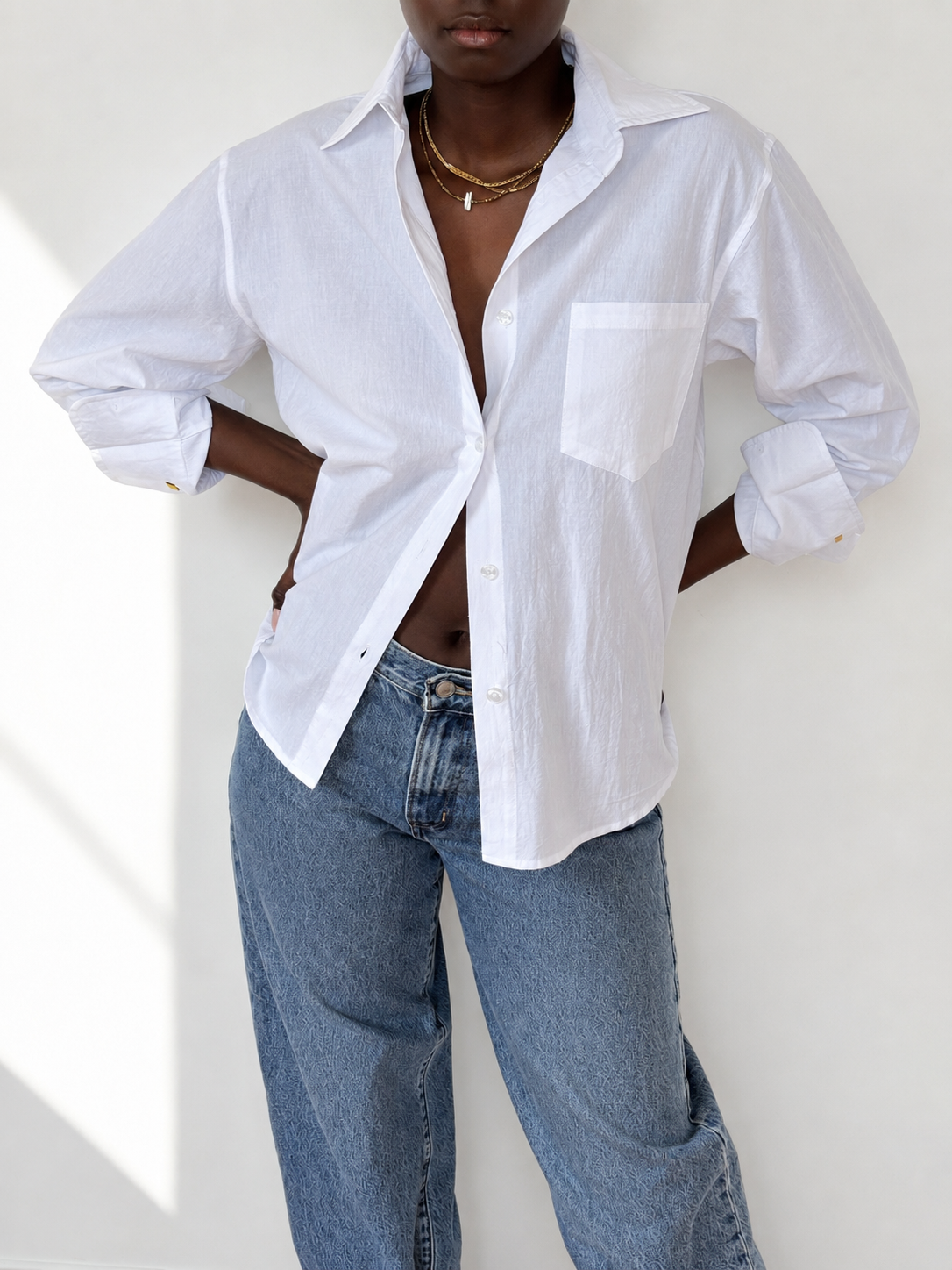 White embroidered cotton Everyday Boyfriend Shirt, relaxed fit, styled with jeans.
